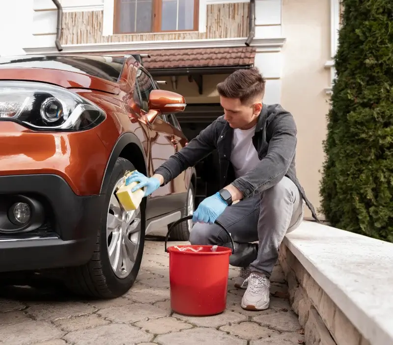 Lavage auto à domicile Ligny-le-Châtel : professionnel intervenant sur un véhicule